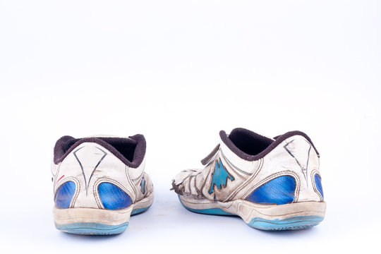 Old worn out futsal sports shoes  on white background  isolated 
