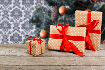 Fototapeta na wymiar Christmas present on decorated tree background, holiday concept