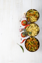 Pasta and ingredients: chili, tomatoes, basil, garlic and parsle