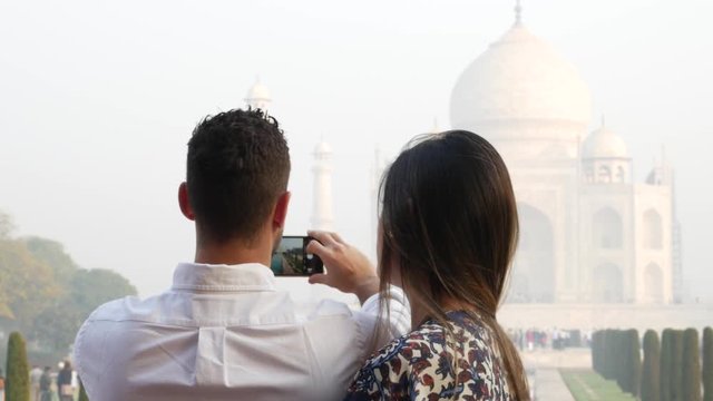 Couple taking a photo in Taj Mahal, Agra, India