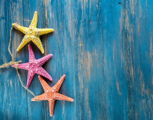 Fototapeta na wymiar starfish on blue wooden