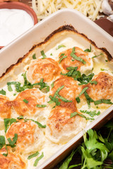 Chicken balls in cream sauce .