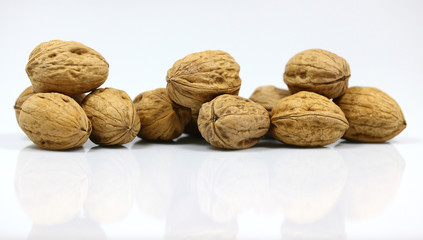 Walnut and a cracked walnut on the white background