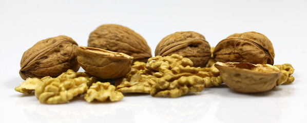 Walnut and a cracked walnut on the white background