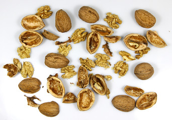 Walnut and a cracked walnut on the white background