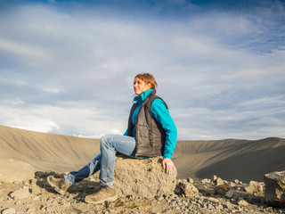 Woman in front of an empty volcanic crater in Iceland
