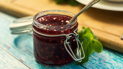 raspberry jam in a jar. selective focus