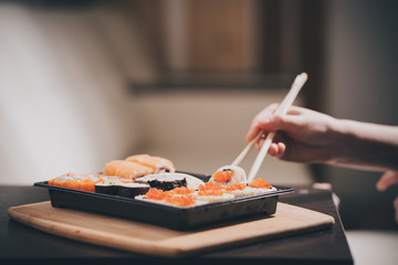Set sushi set. Hand with chopsticks for sushi.
