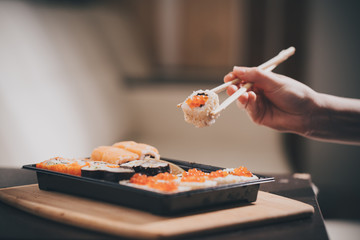 Set sushi set. Hand with chopsticks for sushi.
