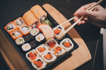 Set sushi set. Hand with chopsticks for sushi.
