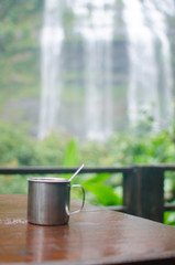 glass of coffee in waterfall background