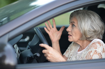 senior woman driving car