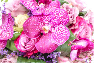 Wedding bouquet made of pink roses and orchids