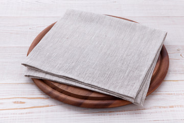 Pizza board with napkin on wooden table. Top view mockup © missty