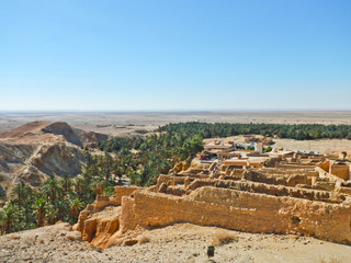 Oasis with ruins of old town in Sahara desert