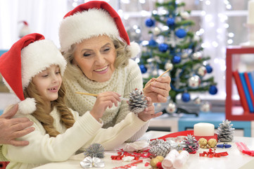 Fototapeta na wymiar Grandmother and child preparing for Christmas