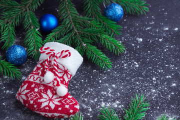 Christmas red stocking on snowbound black background with blue b