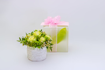 Gift and flowers on a white background