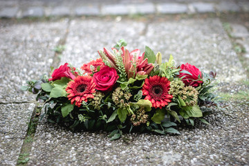 colorful flower arrangement wreath for funerals isolated on white