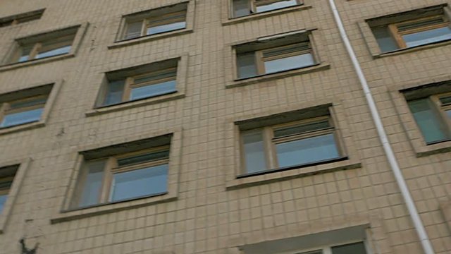 Office or factory block building exterior pan and tilt shot.