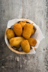  Traditional fried Spanish croquetas (croquettes)  in bowl on wooden background   © chandlervid85