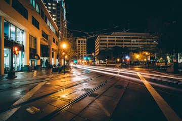Tram tracks and buildings at night, in downtown Norfolk, Virgini