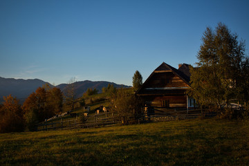 Evening sunset on mountain hills of Simon village. Bran.