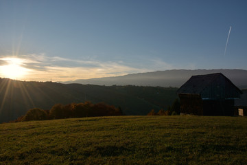 Fototapeta na wymiar Evening sunset on mountain hills of Simon village. Bran.