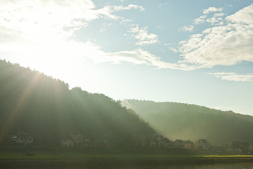 light-flooded landscape with small village in saxony