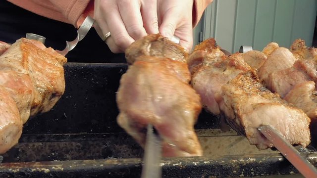 Barbeque skewers with meat cooking on hot coal ember brazier Outdoors picnic concept.