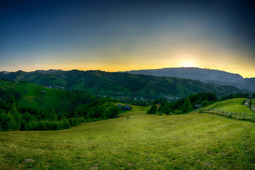 Evening, sunset on mountain hills of Simon village. Bran.