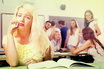 Crying outcast student in college classroom
