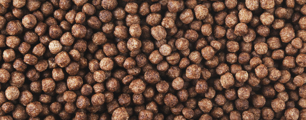 Chocolate corn balls flakes. Panorama.