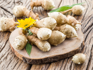 Jerusalem artichoke on wooden table.