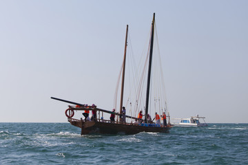Racing traditional dhow in the Arabian Gulf, off Abu Dhabi - obrazy, fototapety, plakaty