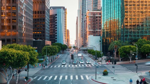 Traffic and people cross at a busy intersection in Downtown Los Angeles