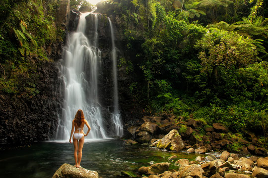 Fototapeta Young woman in bikini standing by Middle Tavoro Waterfalls in Bo