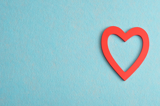 Valentine's Day. A red heart isolated against a blue background
