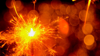 Christmas and New Year party sparkler with abstract circular bokeh background Christmas lights.