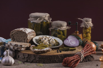 Herrings Pickles. Salted Cucumbers still-life with dark bread