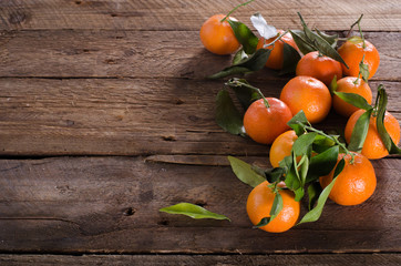 Fototapeta na wymiar Mandarins Tangerines on wooden background. Free space for your text.