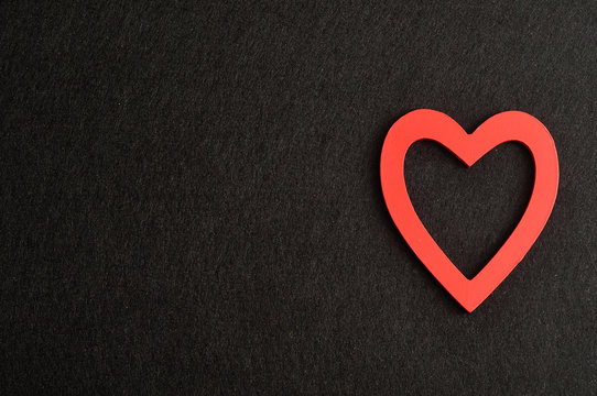 Valentine's Day. A red heart isolated against a black background