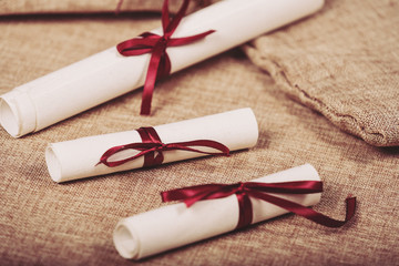 rolled old paper with red bow