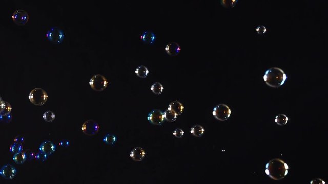 Colorful soap bubbles over black background
