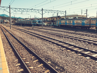 Obraz premium rails at japanese trainstation with some trains in the background