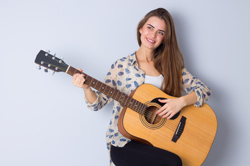 Young woman holding a guitar 