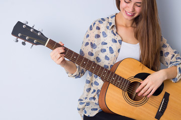Fototapeta premium Young woman holding a guitar 