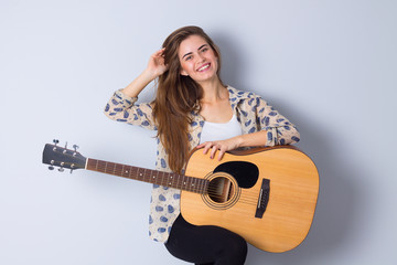 Fototapeta premium Young woman holding a guitar 