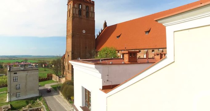 Aerial 4K Medieval Teutonic Knight's brick castle and St. John the Evangelist Cathedral in Kwidzyn, south elevation with panoramic view on Vistula River Valley