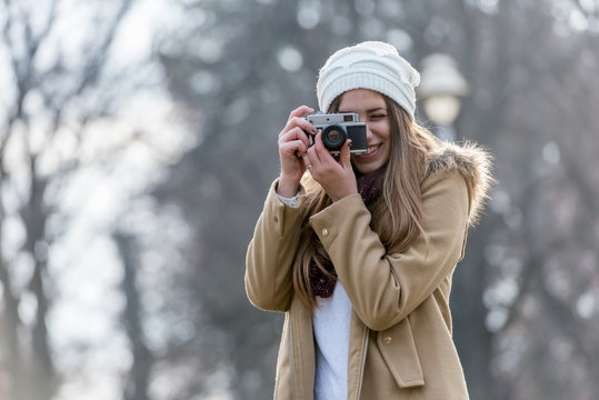 Lifestyle portrait of winter girl with vintage camera